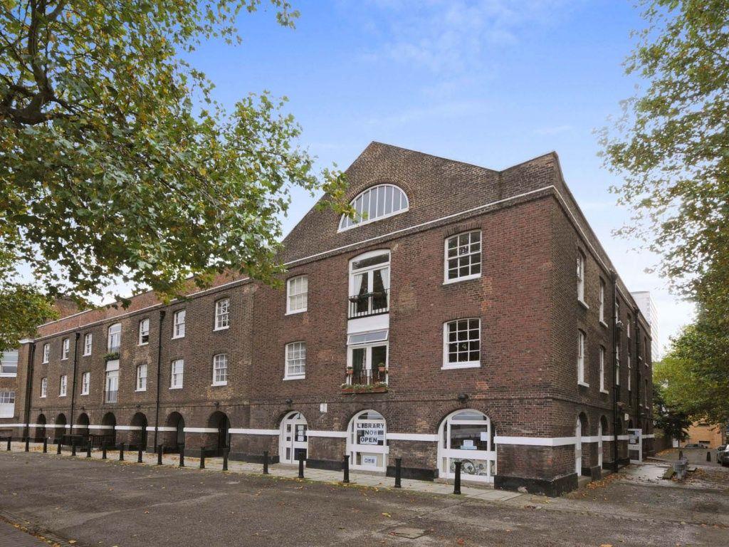 external view of two sotrey brick commercial building converted to residential units
